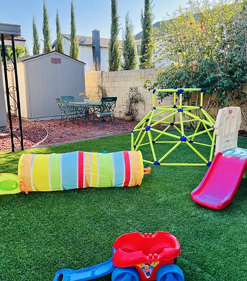 This backyard has part lawn artificial grass to make it always green despite making it a playground or entertainment area. The front yard has real natutal grass.