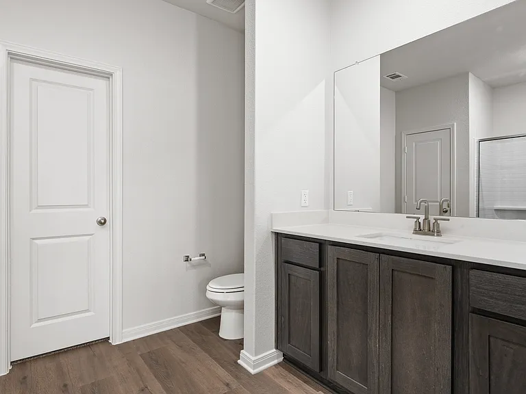 The master bathroom has a sprawling vanity.