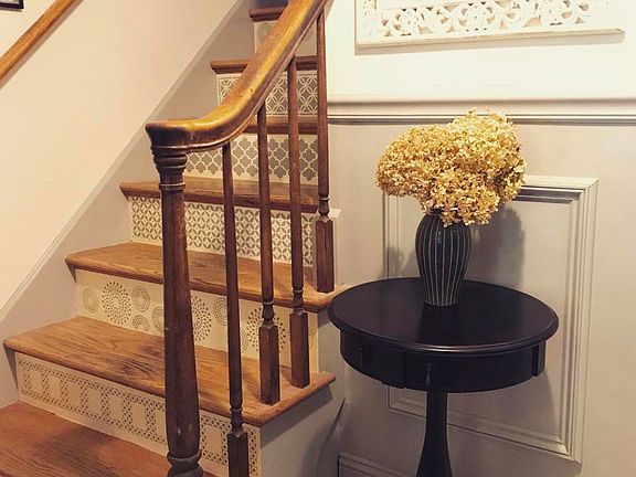 Spacious entry closet, updated wainscoting and art deco staircase