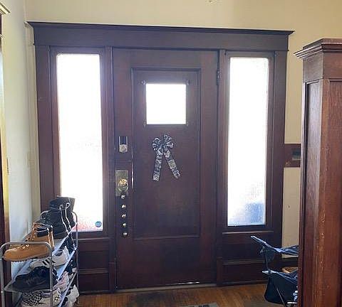 Large entry way. To the left is the living room and to the right is the stairway to the third level.