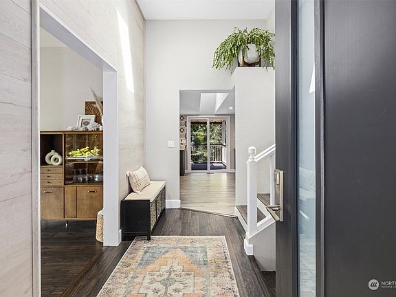The soaring ceilings and skylights in this entryway let in an abundance of natural light, creating a bright and airy space.>