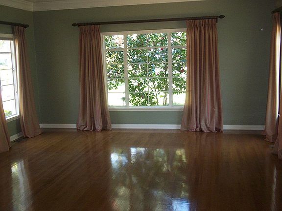 Formal Living Room with hardwood floors and custom drapes