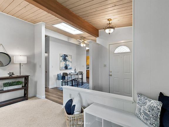 Enter through the front door and you are greeted with the kitchen nook to the right and the family room with fireplace straight ahead. 