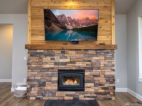 Custom rocked ledgestone fireplace surround & mantle. Wood burning fireplace insert.