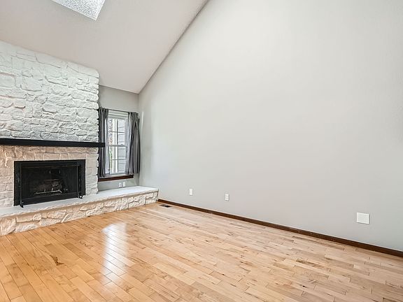 Living room with large white washed fireplace
