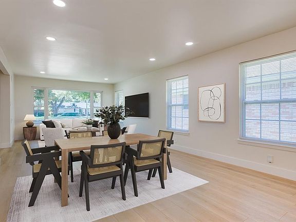 Dining area with baseboards, a healthy amount of sunlight, light wood finished floors, and recessed lighting