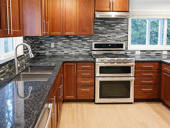 Stainless steel appliances and generous prep space are complemented by natural light, creating a bright, functional heart of the home.