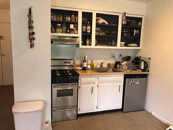 Kitchen with igniting gas stove and oven as well as small re