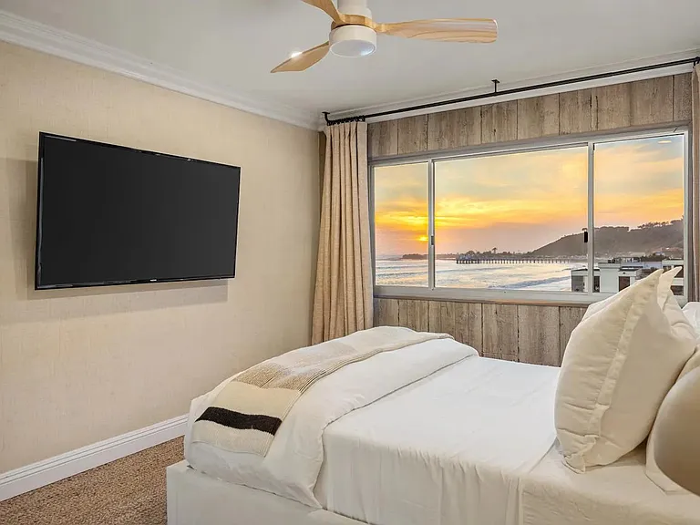 Enjoy the sunset from the comfort of the bedroom, where coastal views meet relaxation.
