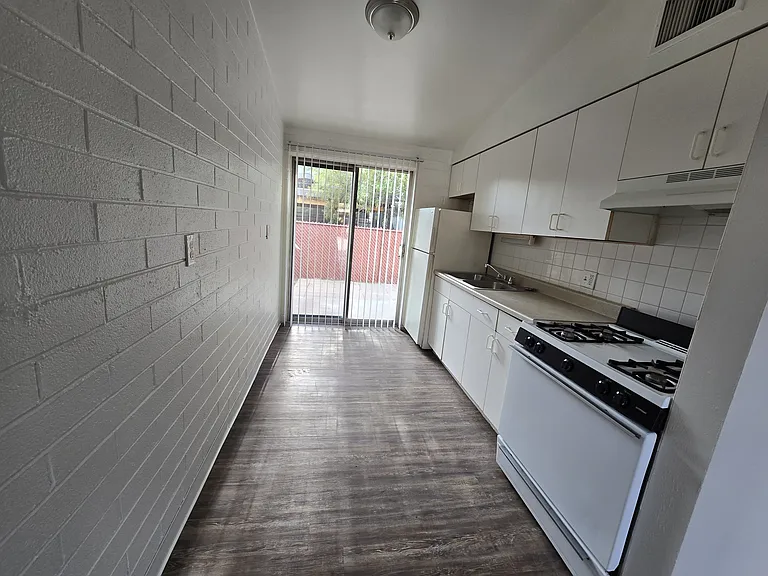 Large Kitchen opening into Backyard.