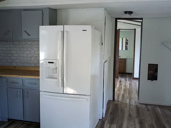 Kitchen includes a dishwasher, fridge and range.