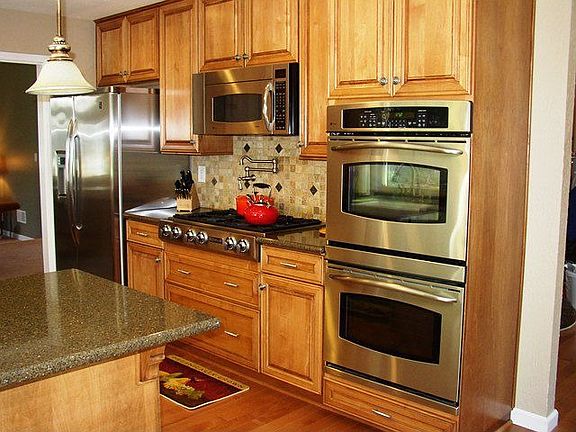 Kitchen with pot faucet and stainless appliances