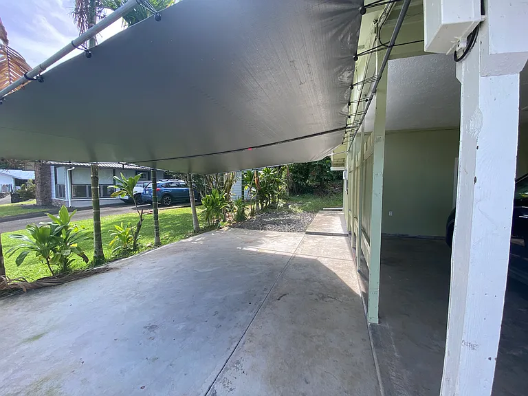 Covered side carport can double as a covered lanai.