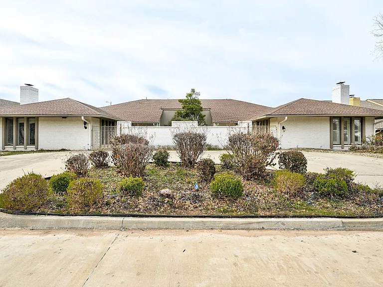 circle drive in front, 2 car attached garage in back