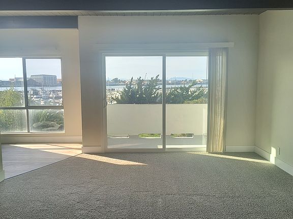 Living room and eat-in kitchen with large floor to ceiling windows