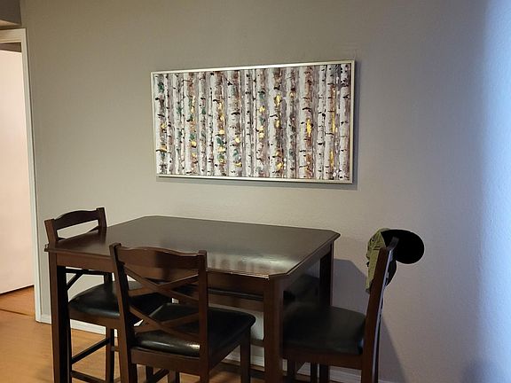 Small elevated dining table looking onto patio