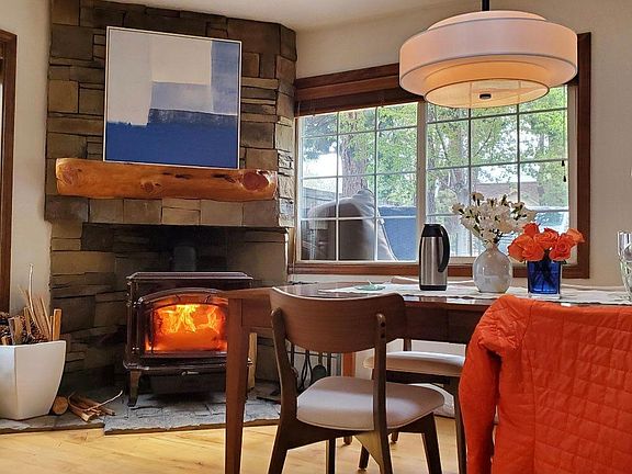 Stone fireplace and wood burning stove. Furniture not included.