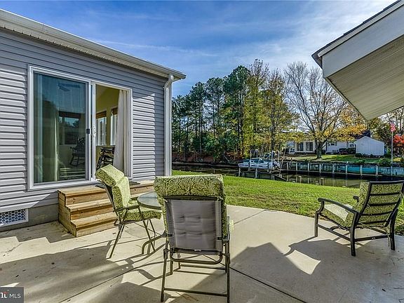 Inviting patio off the new sunroom overlooking the water.
