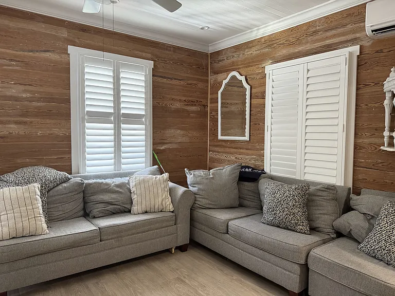 Living room with high ceilings and walls with Dade county pine highlight this home.