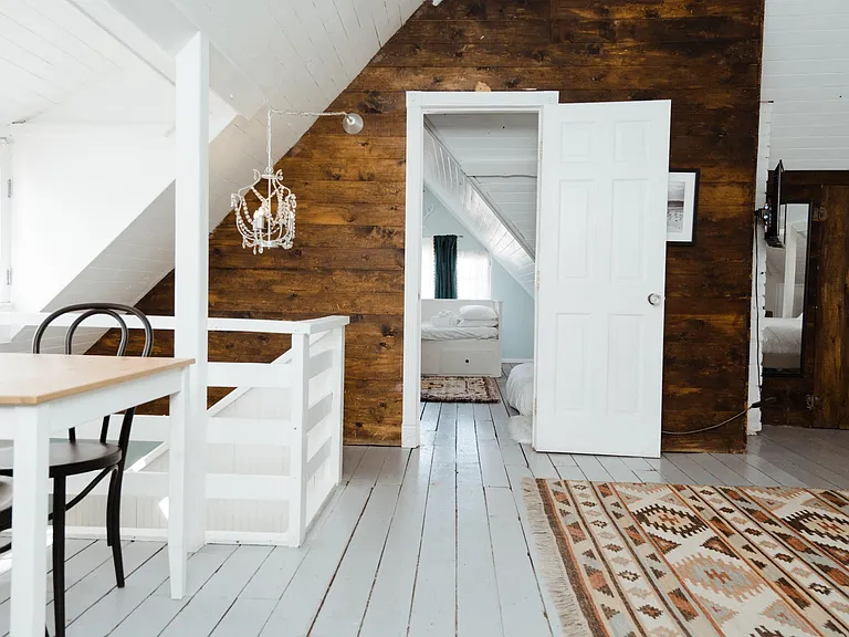 huge upstairs bedroom with soaring 26ft ceiling and wood burning fireplace