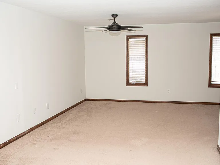 Large primary bedroom upstairs with two walk-in closets