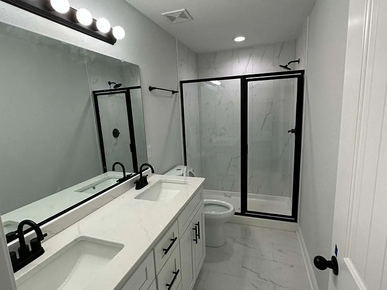 Master bathroom features a double vanity, with a walk in shower, sleek marble style floors, and plenty of space to start your day.