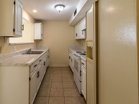 Full Kitchen With Fridge From Hallway View
