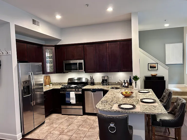 Wood cabinets/granite island and stainless appliance