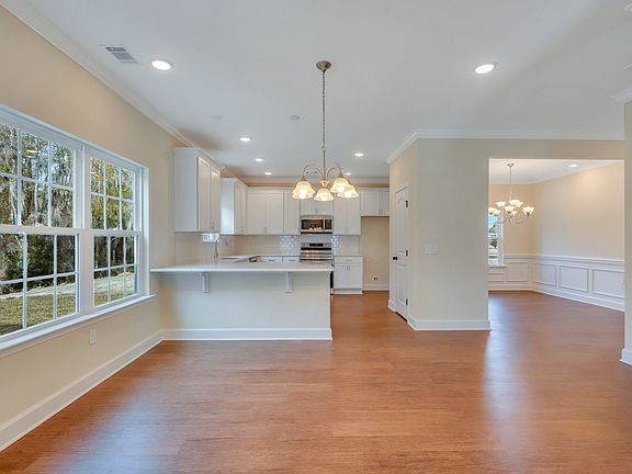 View from family room to breakfast area, dining room, and kitchen - Nantucket plan built by Ernest