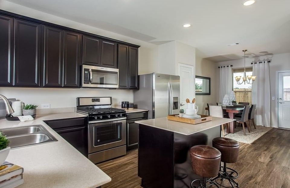 Kitchen. (Photo shown is a builder's reference image of the same floor plan. Image includes furniture and finishes not included in the rental.)