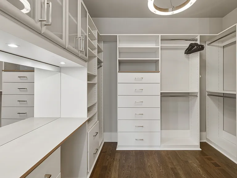 Spacious primary suite featuring a plush king bed, cozy seating area, walk-in closet with custom built-ins, spa-like bath, smart TV and private access to an 11x9 deck. Your private retreat to unwind in comfort.