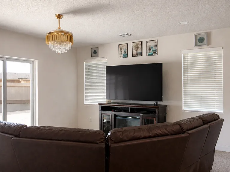 Spacious downstairs living room with abundant natural light.