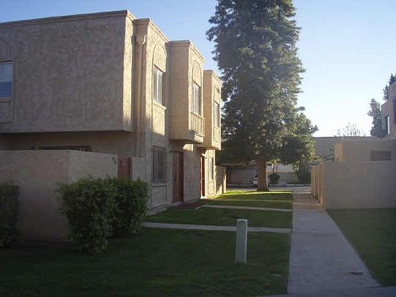 Side view of condo, showing walkway and very nice grass area maintained by HOA