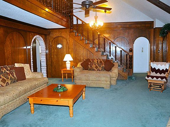 Living room with stairs going up to game room.