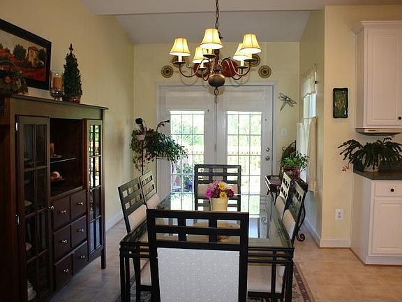 Dining area connects to sunroom with french doors to oversized deck