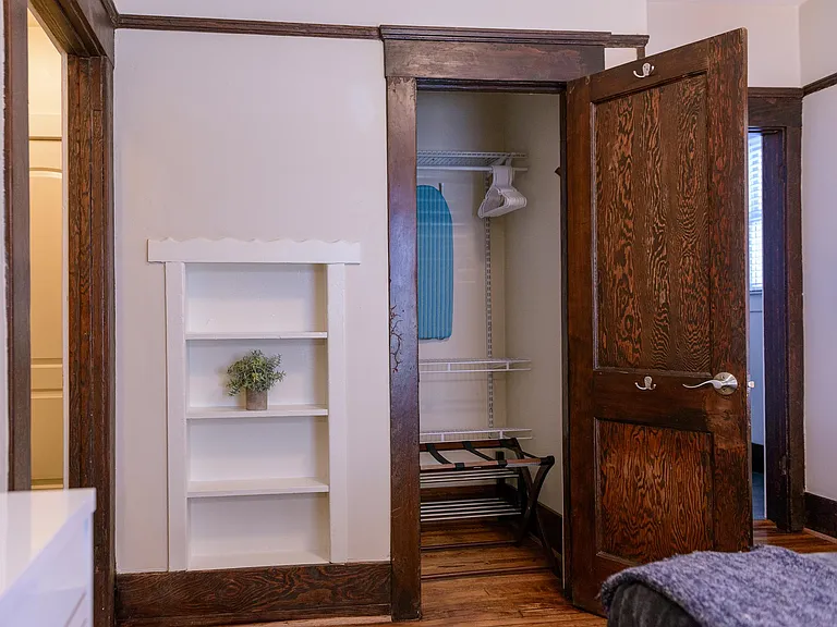 Walk in closet with iron & ironing board