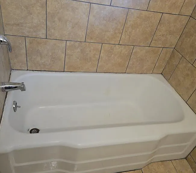 In the bathroom, new tub and sink plumbing fixtures, new floor and wall tile, new vanity, and new vanity cabinet with mirror.