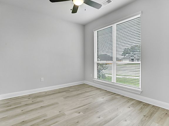 Study located off the entry with large windows, allowing for a bright, open space.