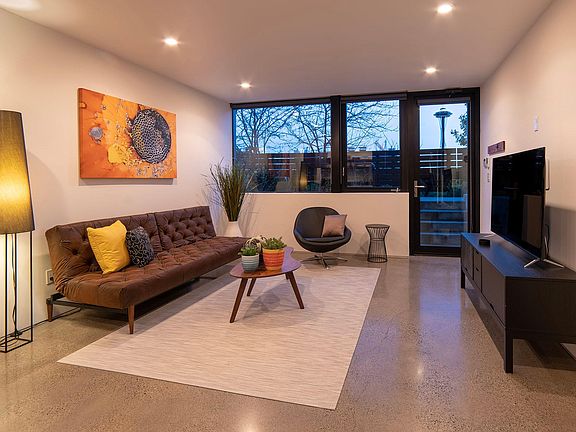 Living room with Space Needle view and 4K smart TV.