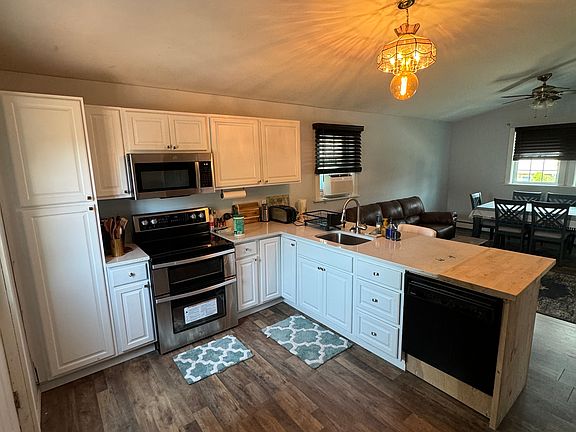 Kitchen area, stove, wood butcher block.