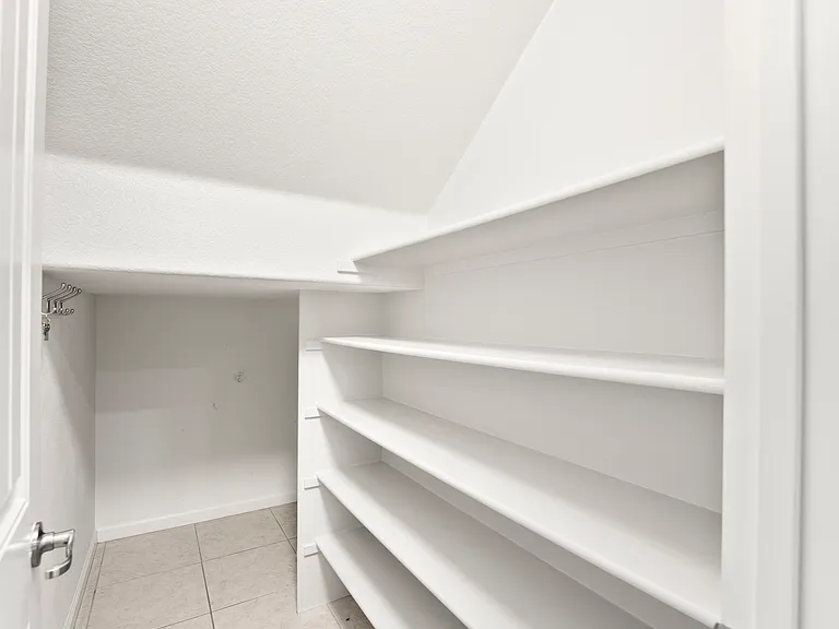 Large pantry and under stairs storage area.