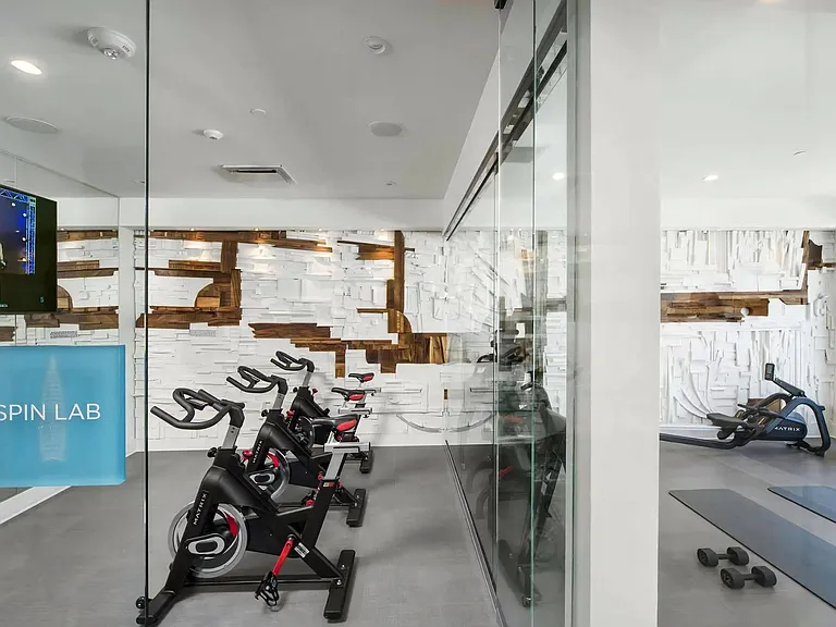 Modern Wellness Space with Indoor Cycling Equipment and Yoga Zone