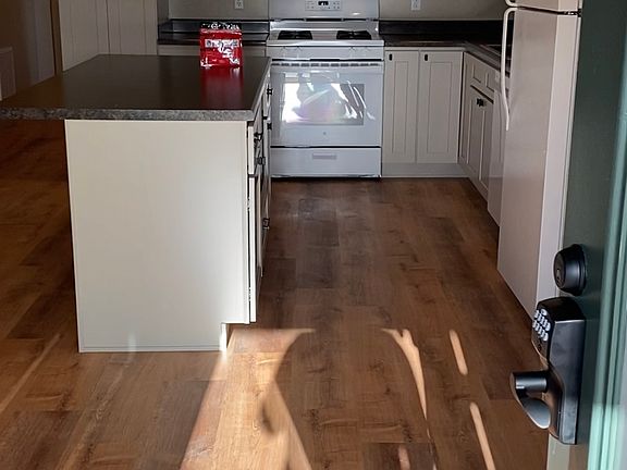 Door opens into the dining room and kitchen. Tall ceilings.