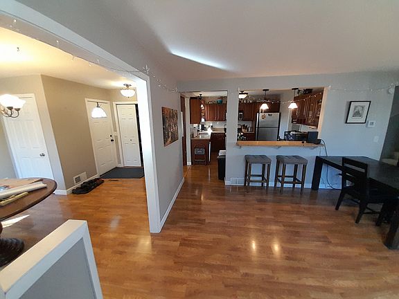 View from Living room of Dining room to left, kitchen ahead and rear entry to left