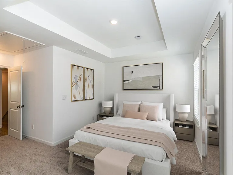 Secondary bedroom with queen size bed and large window letting in a ton of natural light.