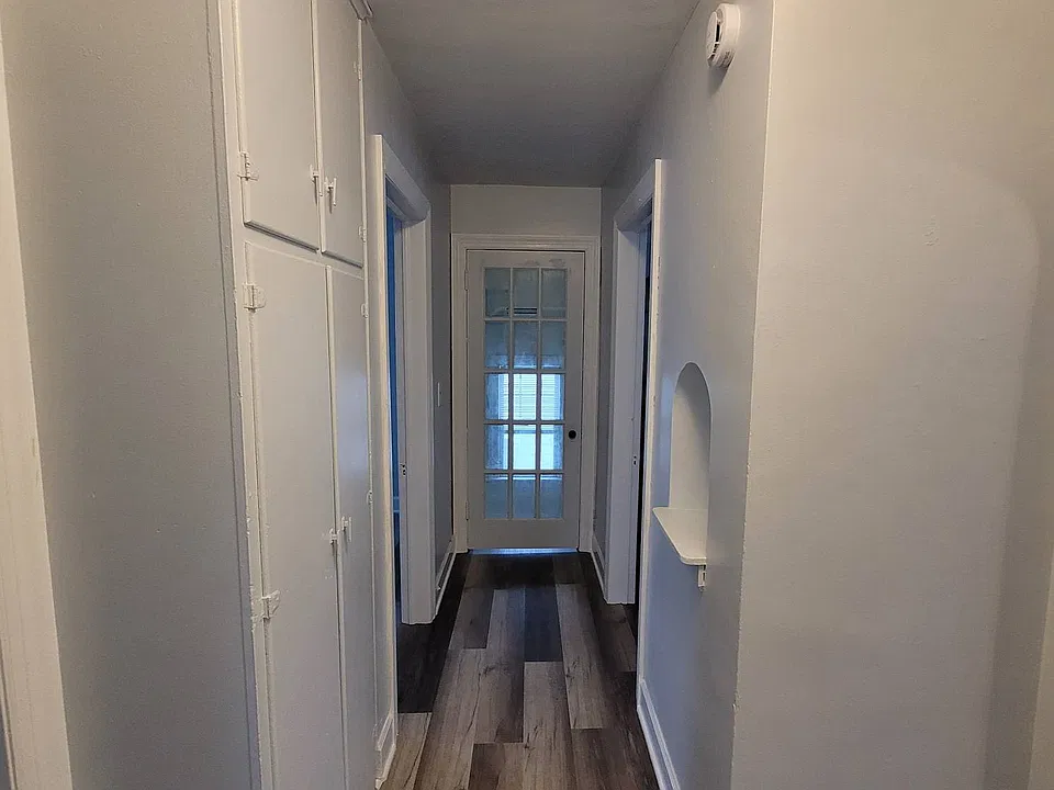 Hallway with built in storage and access to the back yard area