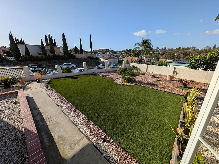 Wide shot of the open space just outside the main entrance of the home.