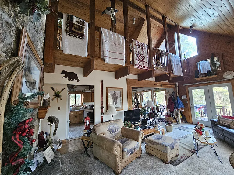 2nd floor living area looking up at loft area. I live on second floor. We share this TV and fireplace room also, I live on second floor in back of house.