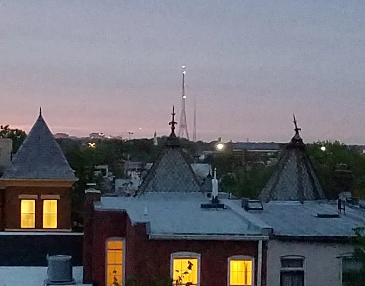 Sunset view out bedroom window, with Eiffel Tower lookalike on the horizon. (More impressive in person.)