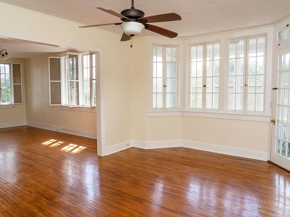 Living room with door to screened-in porch, looking in to dining room